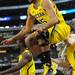 Michigan sophomore Jon Horford leaps into the air as he celebrates a three-point bucket by senior Matt Vogrich during the last minute of play against Florida at Cowboys Stadium on Sunday, March 31, 2013. Melanie Maxwell I AnnArbor.com